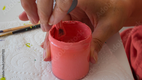 female hands painting polymer clay. Handmade workshop composition of clay, beads, tools and paint in studio