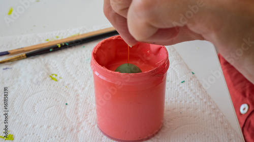 female hands painting polymer clay. Handmade workshop composition of clay, beads, tools and paint in studio