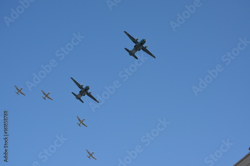 A group of Two Fixed Wing Aircrafts and Four Gray Fighter Aircrafts Going Together Upwards