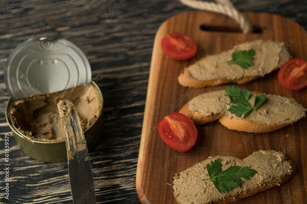 Liver pate on the bread on wooden tray. Liver pate on the bread on wooden tray.