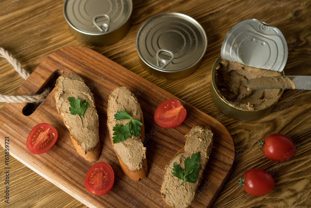Liver pate on the bread on wooden tray. Liver pate on the bread on wooden tray.