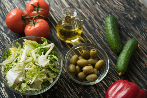 Salad ingridients. Tomato, lettuce, paprika, cucumber and olive oil.