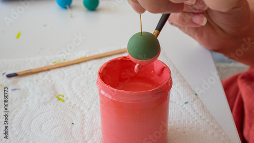 female hands painting polymer clay. Handmade workshop composition of clay, beads, tools and paint in studio