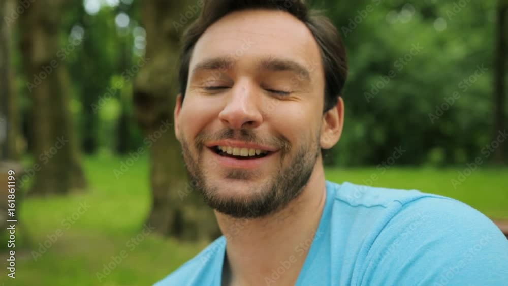Close up portrait of young attractive fittness man in the park smiling at the camera Close up portrait of young attractive fittness man in the park smiling at the camera