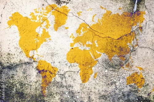 Yellow world map on damaged cracked concrete wall. Elements of this image furnished by NASA.