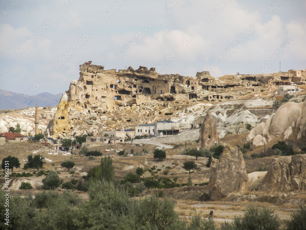 Small village and rock formations in Cappadocia's landscape