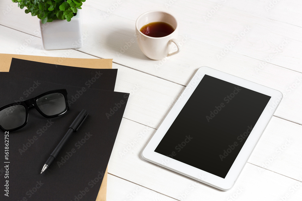 Modern workplace with digital tablet computer and mobile phone, cup of coffee, pen and empty sheet of paper. Modern workplace with digital tablet computer and mobile phone, cup of coffee, pen and empty sheet of paper.