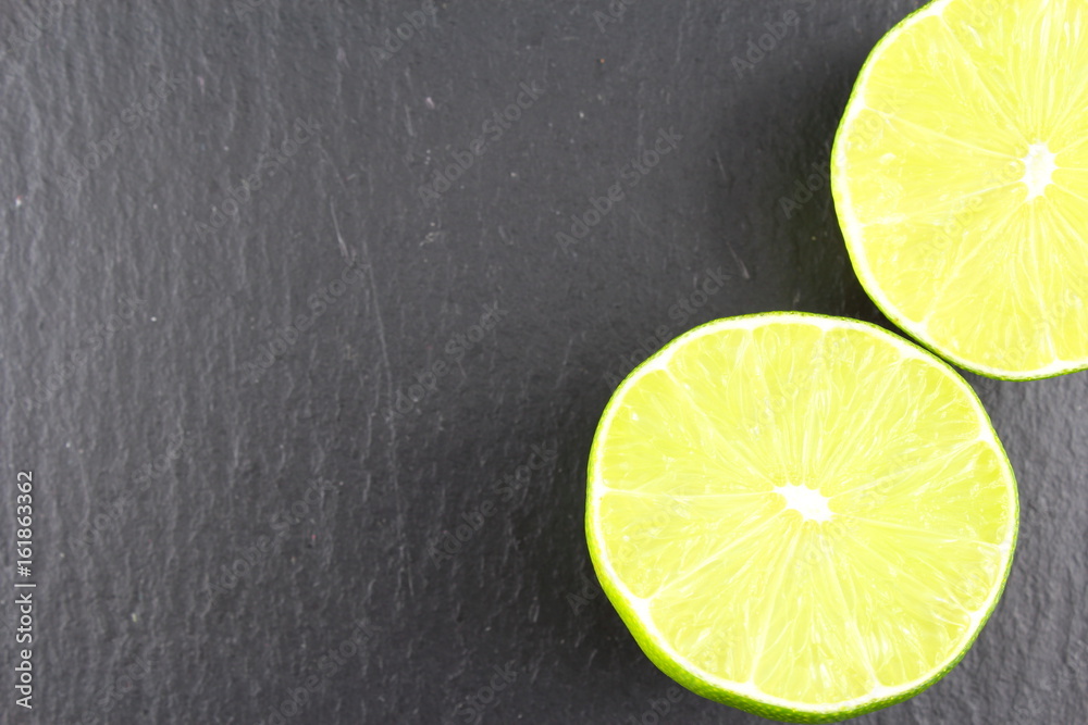 fresh lime fruit on a slate plate food background texture fresh lime fruit on a slate plate food background texture