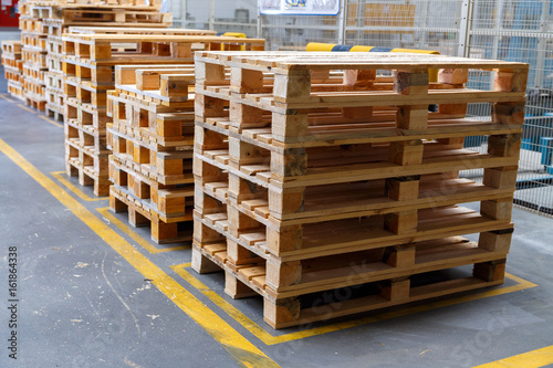 Stacked wooden pallets at a storage