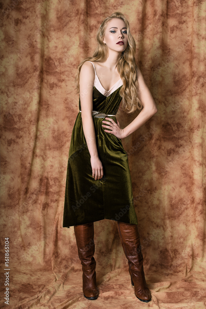 Beautiful fashion model in a velvet green dress. Vintage. Luxury style. Beautiful fashion model in a velvet green dress. Vintage. Luxury style.