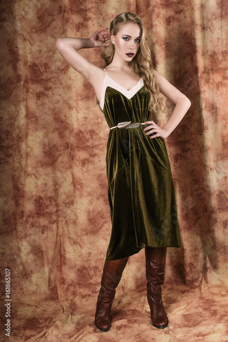 Beautiful fashion model in a velvet green dress. Vintage. Luxury style.