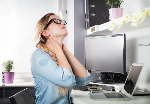 Konstfotografi Woman in home office suffering from neck pain sitting at desk