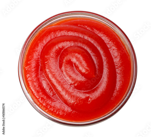 glass bowl of ketchup isolated on white background, top view