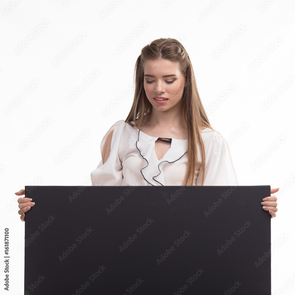 Young sexy woman portrait of a confident businesswoman showing presentation, pointing placard black background. Ideal for banners, registration forms, presentation, landings, presenting concept.. Young sexy woman portrait of a confident businesswoman showing presentation, pointing placard black background. Ideal for banners, registration forms, presentation, landings, presenting concept..