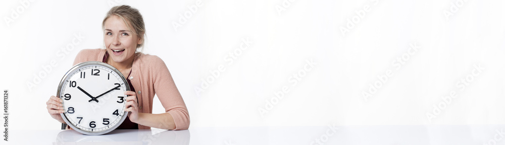 laughing beautiful young woman displaying a clock, long banner laughing beautiful young woman displaying a clock, long banner