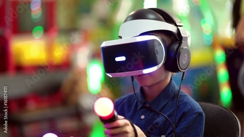 The boy plays in virtual reality on the console, in an entertainment park
