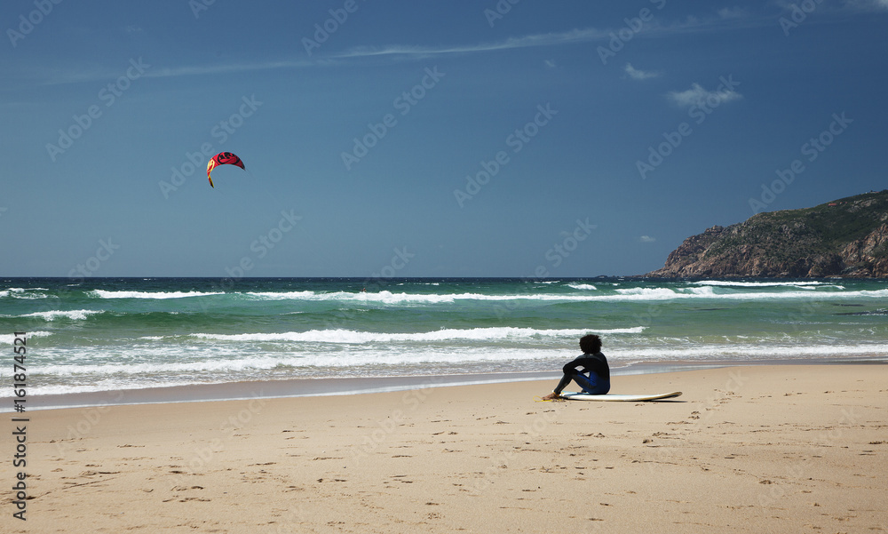 Obraz premium Surfer sitting on the beach