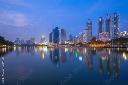 Bangkok cityscape at blue hour with the park and many building view on skyscraper. © Surapong