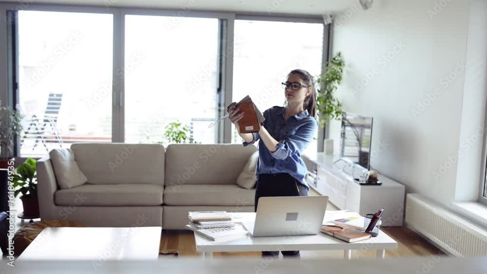 Female designer with fabric sampler working from home. Female designer with fabric sampler working from home.