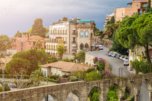 Taormina, Sicily - Beautiful view of the famous hilltop town of Taormina with streets, trees and sunshine