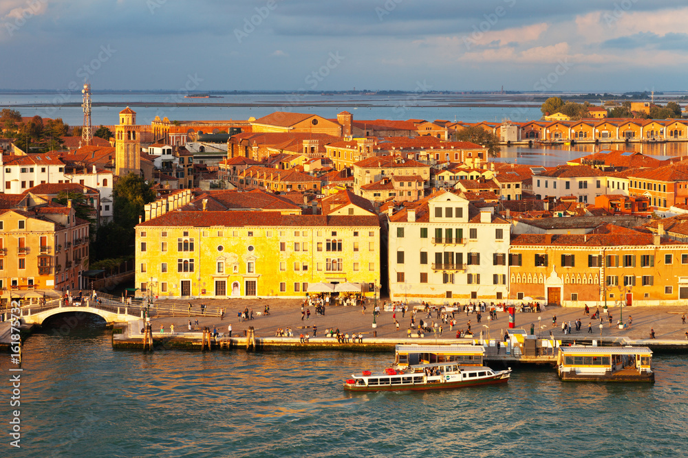 Top view of the Castello district and Arsenale water bus stop on the San Marco Channel from above in the rays of the setting sun