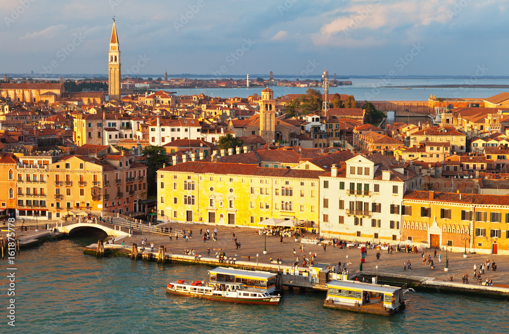  Top view of the Castello district,  embankment Riva Ca di Dio and Arsenale water bus stop on the San Marco Channel  in the rays of the setting sun