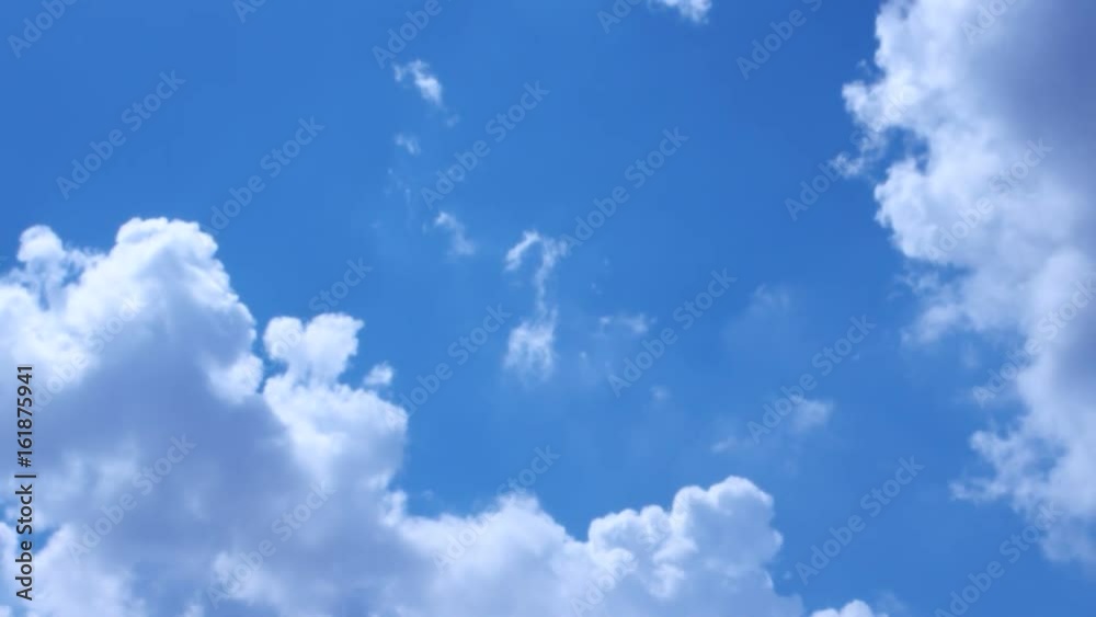 White clouds run against the blue summer sky White clouds run against the blue summer sky