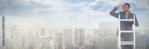 Composite image of businessman standing on ladder looking