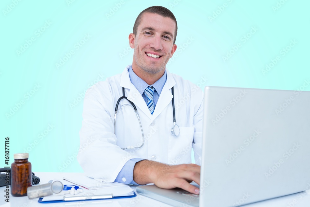 Portrait of smiling businessman using laptop