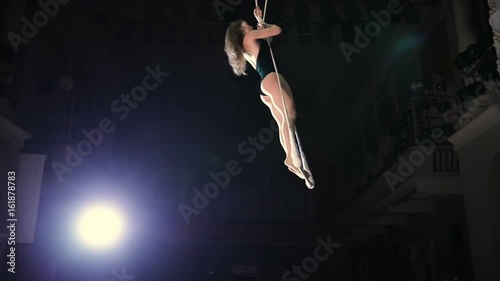 Slowmotion of female circus artist on a trapeze bar photo