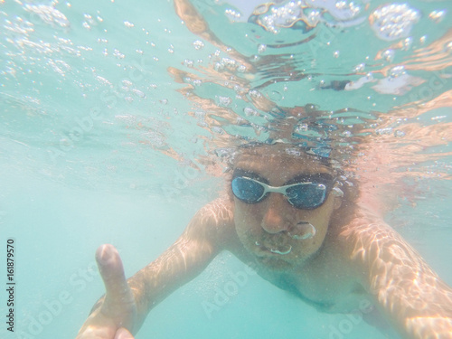 Underwater view of a man swimming in the sea