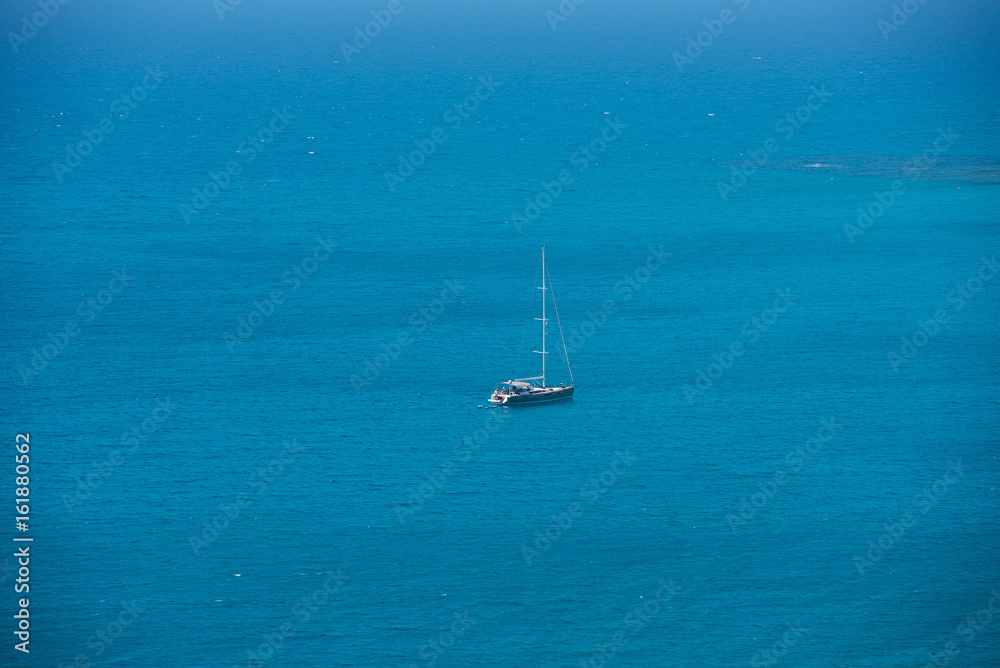 Alone yacht sailing in open sea. Travel concept