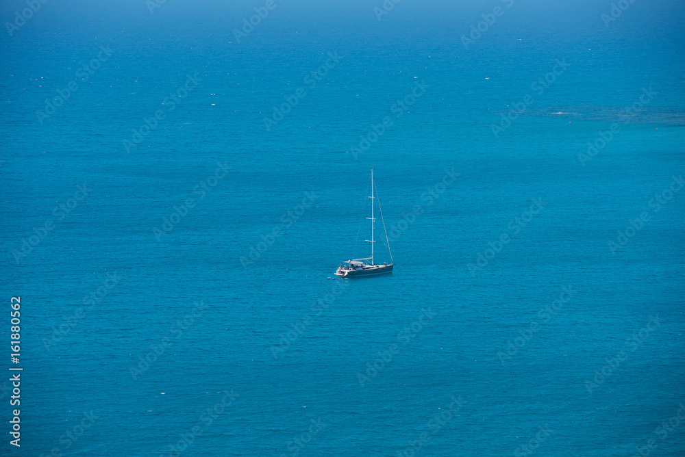 Alone yacht sailing in open sea. Travel concept Alone yacht sailing in open sea. Travel concept