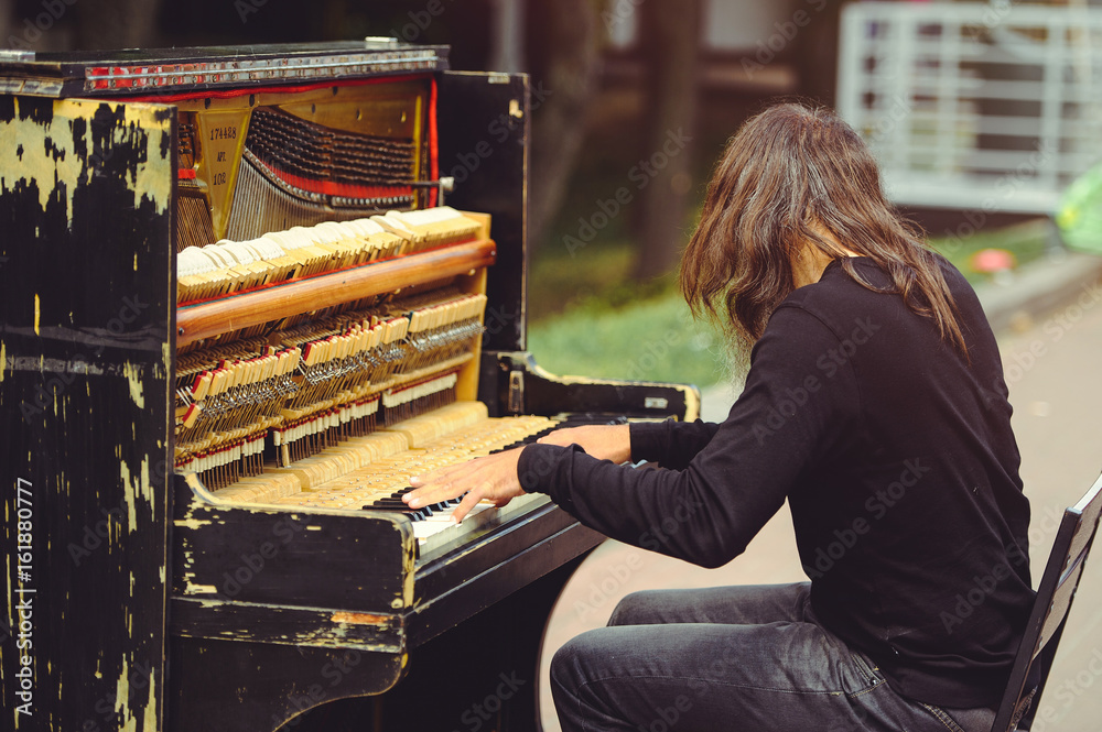 Man on the street playing the piano
