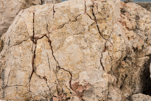 Background quarried rough textured limestone rock