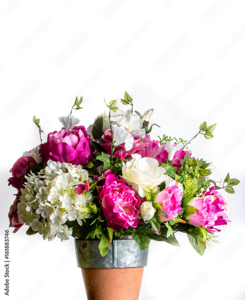 Closeup bouquet of artificial flowers. Ornamental bouquet in red bucket on white background. Vintage bloom decoration. Closeup bouquet of artificial flowers. Ornamental bouquet in red bucket on white background. Vintage bloom decoration.