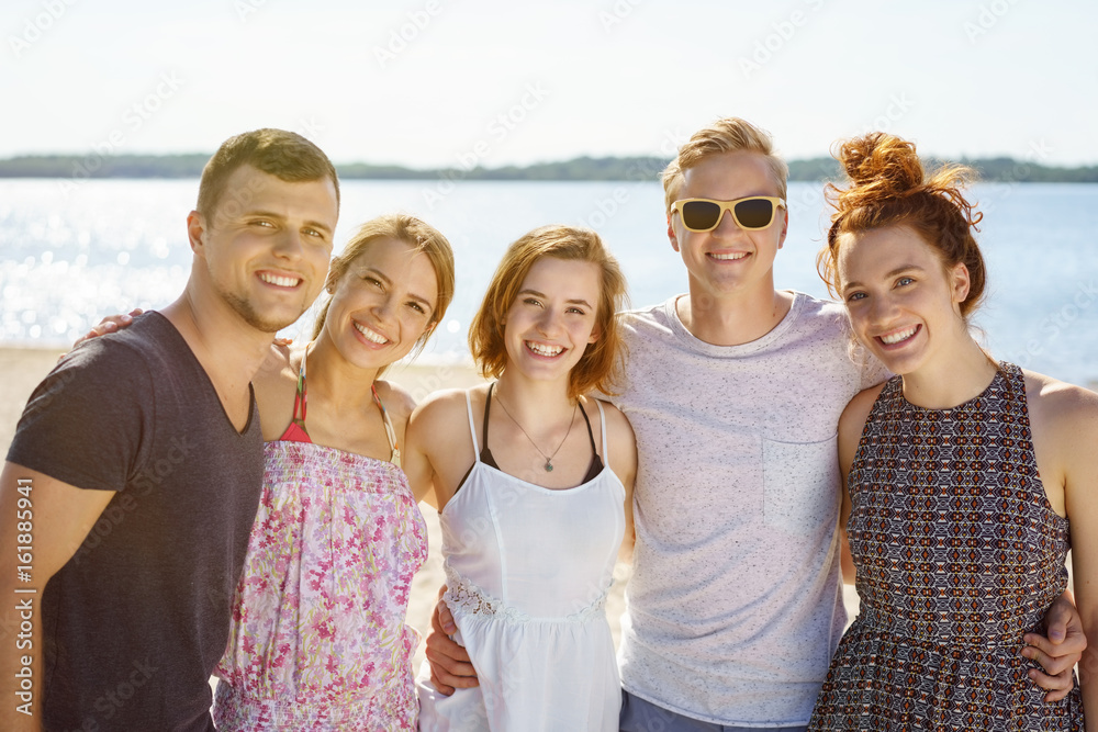Happy group of young university students on a beach Happy group of young university students on a beach