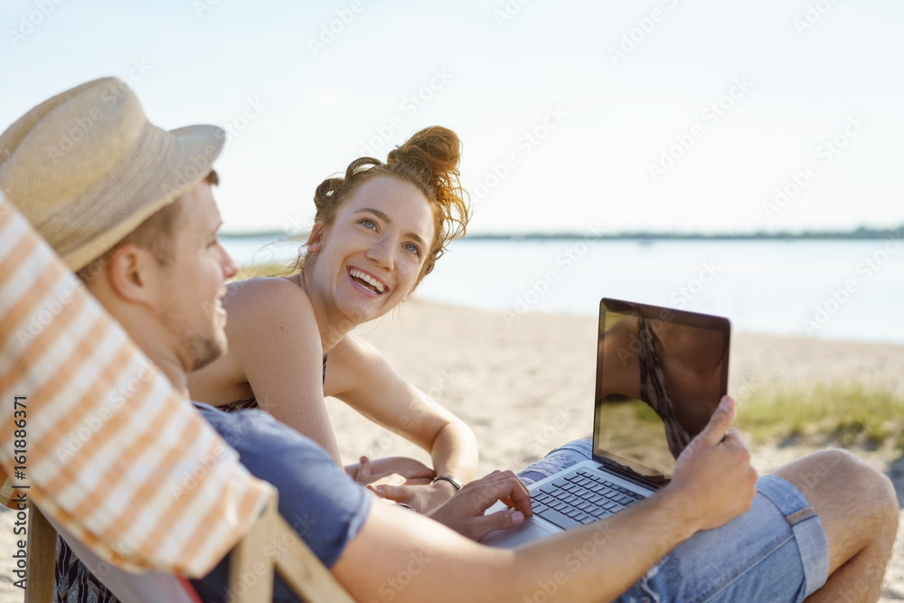 Young couple enjoying a summer day at the beach Young couple enjoying a summer day at the beach