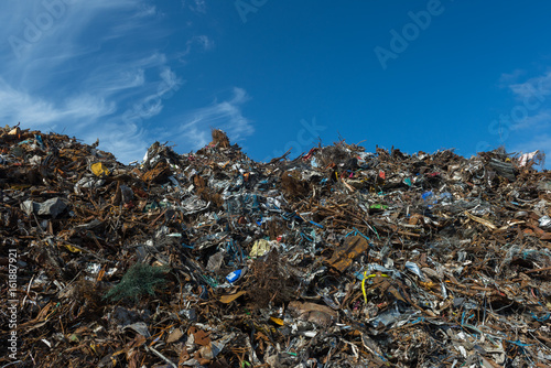 Scrap metal piled up and blue sky background