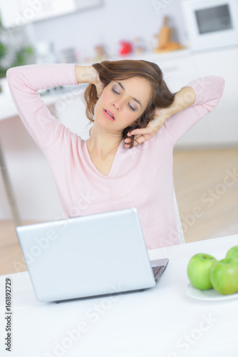 tired woman with laptop computer photo