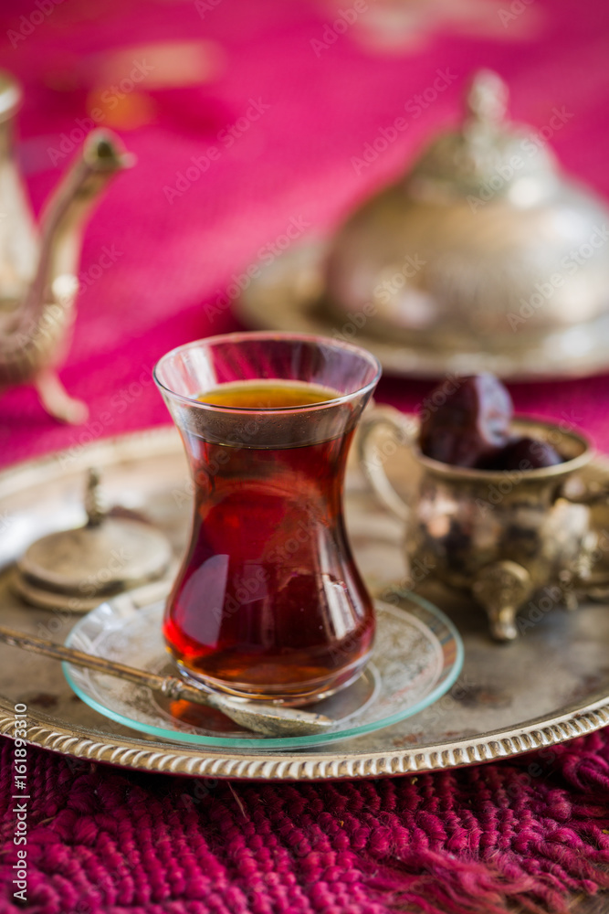 Fototapeta premium Tea set in oriental style in pear shaped glass with vintage kettle and dates fruit