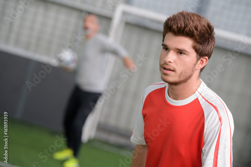 fooballer training exercise with coach photo