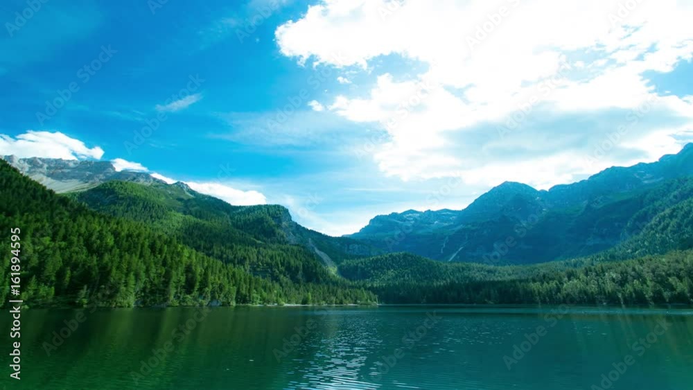 Lake and Mountains LandscapeHyper Time lapse of mountain lakeBeautiful clear blue mountain lake with large mountains in the background on a sunny day - Lago di Tovel Lake and Mountains LandscapeHyper Time lapse of mountain lakeBeautiful clear blue mountain lake with large mountains in the background on a sunny day - Lago di Tovel