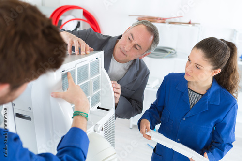 student learns air conditioning repair from an experienced instructor