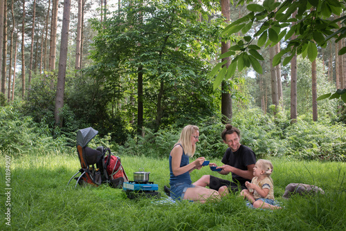 Backpackers family dining in nature