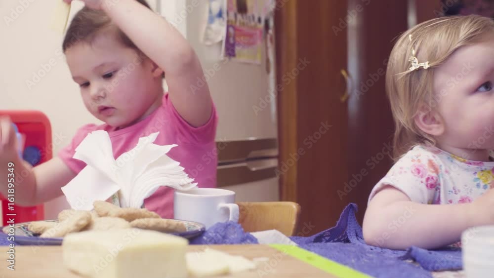 Two sisters having breakfast at the table.