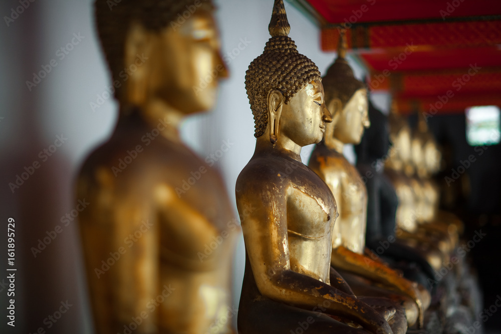 Row of gilded Buddhas, temple statues from Thailand Row of gilded Buddhas, temple statues from Thailand
