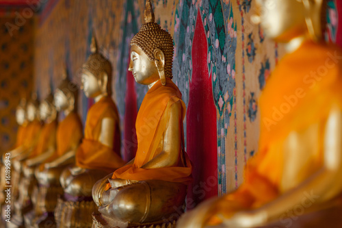 Row of gilded Buddhas  temple statues from Thailand