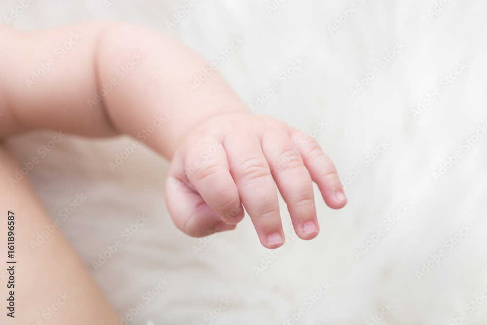 Hand of cute little baby on bed, closeup Hand of cute little baby on bed, closeup