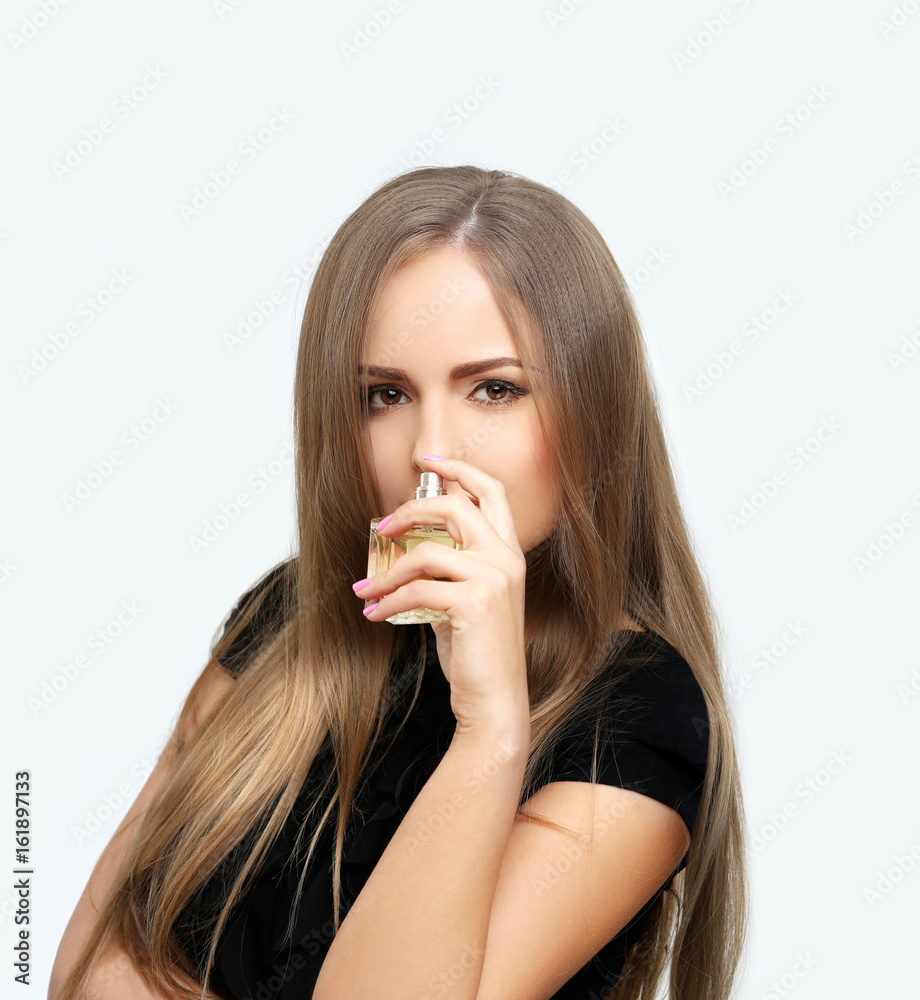 Perfume. Young girl smelling aroma with pleasure Perfume. Young girl smelling aroma with pleasure